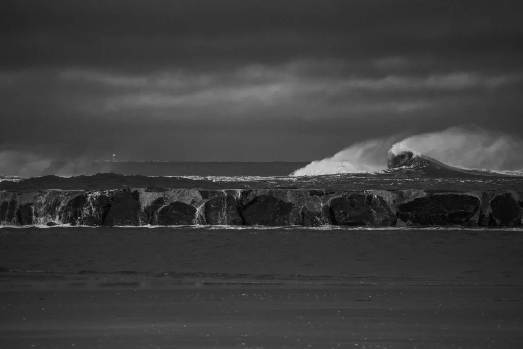 Black and white surf photography of waves coming into harbor big wave photography